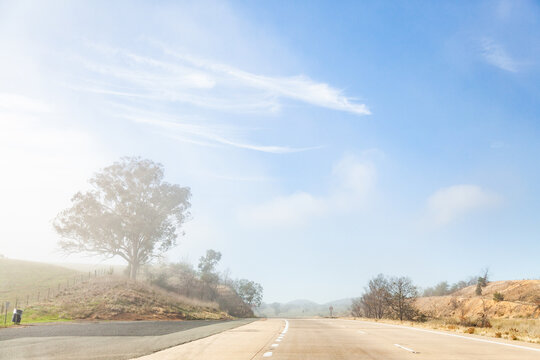 Changing weather conditions on highway sunlight and fog