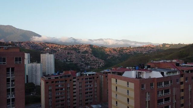 Aerial view of the Petare slum in the city of Caracas, Venezuela, at sunset. Bird eye view of a slum in a big city in South America. Latin america inequality