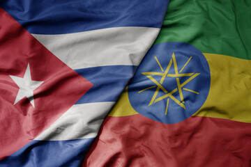big waving national colorful flag of ethiopia and national flag of cuba .