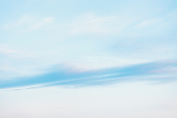 Fototapeta premium A beautiful sky tinted by the sun leaving vibrant shades of gold, pink, blue and multicolored. Clouds in the twilight evening and morning sky. Cloudy sky background in the evening and during the day.