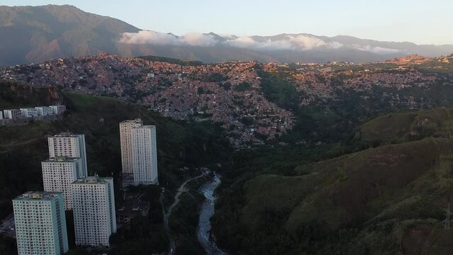 Aerial view of the Petare slum in the city of Caracas, Venezuela, at sunset. Bird eye view of a slum in a big city in South America. Latin america inequality