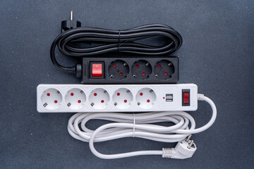 Electrical outlet extension cord. White cable with USB connector for charging phones. Electrical appliance. Extension cable.