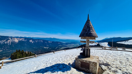 Hiker man at wooden monument at Dreilaendereck, Karawanks, Carinthia, Austria. Triangle border...