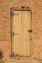 Traditional wooden door in a brick wall