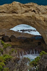 View of a rocky shoreline with thin, jagged rocks jutting out from the water's edge