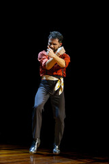 Fototapeta na wymiar Expressive flamenco dance performance on stage, copy space.
