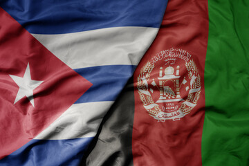 big waving national colorful flag of afghanistan and national flag of cuba .
