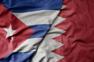 big waving national colorful flag of bahrain and national flag of cuba .