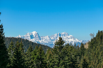 Obraz premium Scenic view of snowcapped mountain peaks of Julian Alps seen from Dreilaendereck, Karawanks, Carinthia, Austria. Hiking in remote alpine landscape in early springtime in Austrian Alps. Wanderlust