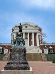 Naklejka premium Large bronze statue stands atop a set of brick steps in a University of Virginia Rotunda