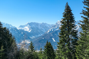 Scenic view of snowcapped mountain peaks of Julian Alps seen from Dreilaendereck, Karawanks, Carinthia, Austria. Hiking in remote alpine landscape in early springtime in Austrian Alps. Wanderlust