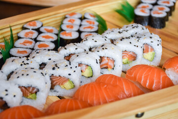 Colorful sushi set with rice. Garnish with pickled ginger and wasabi. Rolled sushi with avocado, mushrooms, tuna, salmon and sesame. With red caviar. Japanese food