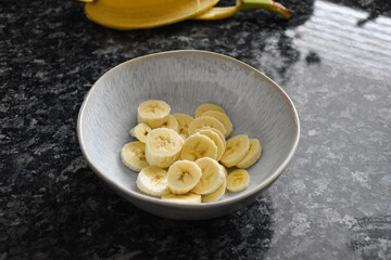 Ceramic bowl with sliced banana.