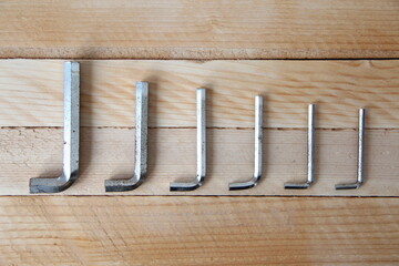 Set of hex keys on wooden background