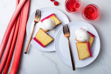 Fresh loaf cake decorated with roasted rhubarb. Sweet and delicious rhubarb dessert with ice cream