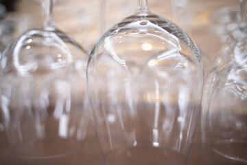 Close-up of wine glasses hanging in a holder in a bar. Apply light and blur effects