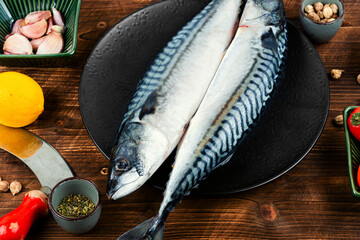 Raw mackerel fish on wooden background.