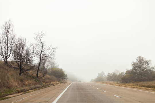 Low visibility driving in fog cloud