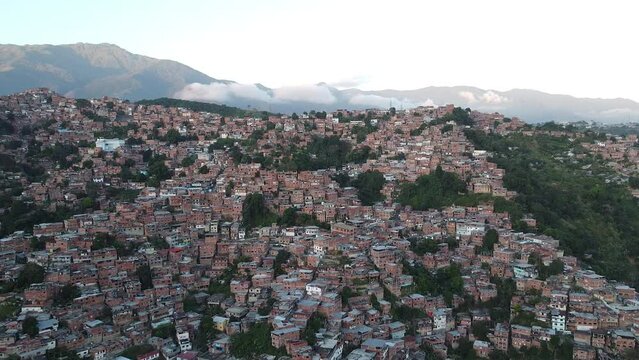 Aerial view of the Petare slum in the city of Caracas, Venezuela, at sunset. Bird eye view of a slum in a big city in South America. Latin america inequality