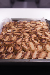 Baking of traditional roll apple cake with nuts, raisins and cinnamon covered with egg white snow