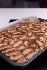 Baking of traditional roll apple cake with nuts, raisins and cinnamon covered with egg white snow
