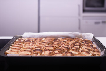 Baking of traditional roll apple cake with nuts, raisins and cinnamon covered with egg white snow