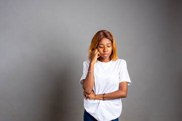 unhappy young lady isolated in a grey background