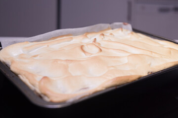 Baking of traditional roll apple cake with nuts, raisins and cinnamon covered with egg white snow