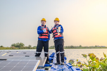 Skilled technicians supervise operations at a floating solar farm at sunset.