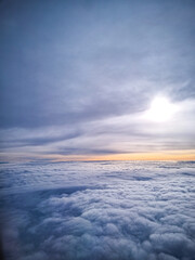 Over the Sky and cloud in afternoon, shooting from window of airplane - vertical