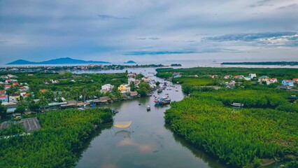 Fototapeta na wymiar Aerial view, tourists are relax and experiencing a basket boat tour at the coconut water (mangrove palm ) forest in Cam Thanh village, Hoi An,Quang Nam,Vietnam