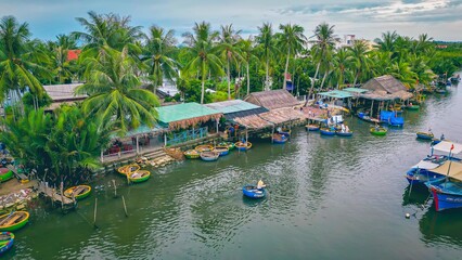 Fototapeta na wymiar Aerial view, tourists are relax and experiencing a basket boat tour at the coconut water (mangrove palm ) forest in Cam Thanh village, Hoi An,Quang Nam,Vietnam