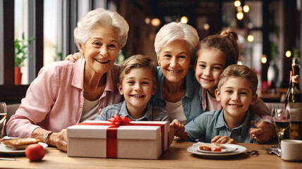 Grandmothers and grandchildren dine together in a restaurant on Mother's Day. Mother's Day concept - obrazy, fototapety, plakaty