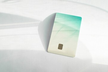 Closeup of a gradient white and blue credit card isolated on an empty surface