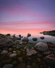 AI generated illustration of a stunning shoreline illuminated by a golden sunset, Finland