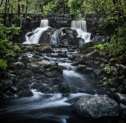Obraz premium AI generated illustration of a picturesque river flowing underneath a rustic bridge, Finland