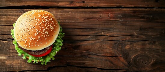 Fast food restaurant or menu design featuring a hamburger on a wooden backdrop.
