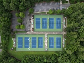 Aerial shot of the tennis courts and dense trees