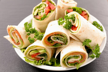 Sandwich wrap with salmon, avocado and lettuce- Healthy lunch snack