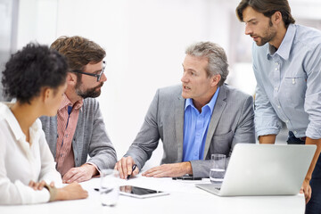 Businesspeople, laptop and teamwork in office or brainstorming startup for project planning, solution or internet. Men, woman and talking in boardroom or creative proposal, problem solving or online