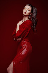 Fototapeta premium Studio fashion: gorgeous sensual young woman dressed in red skirt and blouse. Portrait of sweet lovely girl