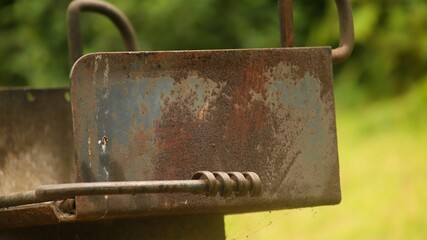 Closeup of a rusty piece of an old car in the countryside