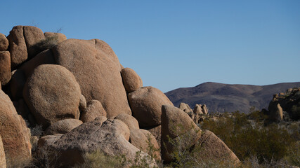 Scenic view of a bright blue sky with rocks and bushes