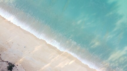 Aerial view of the sea and a beautiful beach on a sunny day
