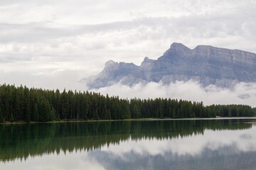 Serene lake is surrounded by snow-capped mountains inBanff, Alberta, Canada