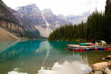 Scenic view of several canoes resting in shallow waters of the Lake Moraine