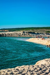 Portugal, a beach with beautiful white sand is illuminated by sparkling sunshine
