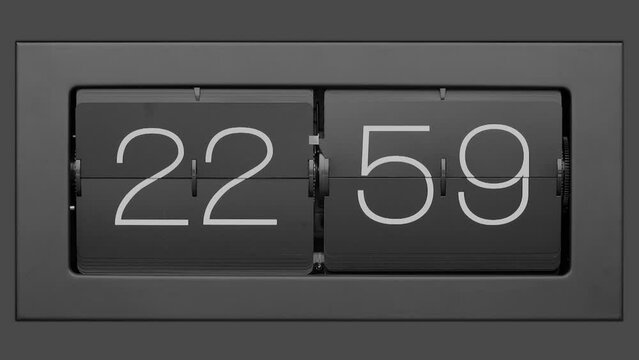 Retro flip clock changing from 22:59 to 23:00. Slow motion. Close up. 