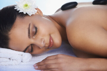 Obraz na płótnie Canvas Sleeping, hot stone or woman with flower in spa for wellness, treatment or hospitality. Relax, resort or salon with female person, client or masseuse in hotel on holiday vacation for beauty therapy