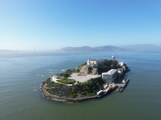 Drone view of the Alcatraz Island under a blue sky and sunlight in California